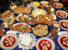 a table filled with plates and bowls of food