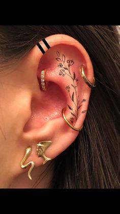 a woman wearing ear piercings with flowers on them