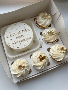 a box filled with lots of cupcakes on top of a white countertop