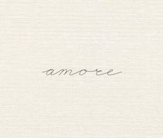 the word amoe is written in cursive handwriting on a white paper background