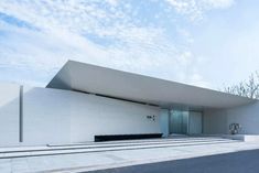 a white building sitting on the side of a road