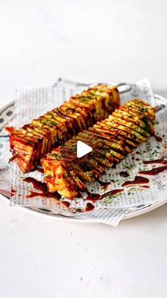 grilled vegetable skewers with ketchup drizzled on them