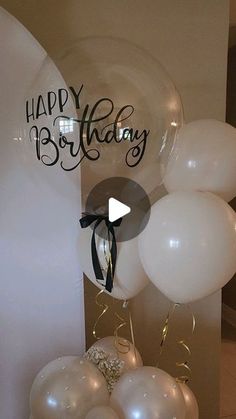 balloons and streamers in front of a happy birthday sign