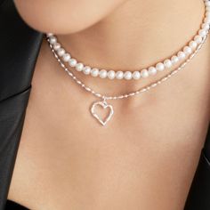 The Julia Beaded Pearl Choker is a classic accessory for any look. It features chic, hand-beaded natural freshwater pearls that offer unique beauty and elegance. It is a timeless piece you can enjoy for years to come. Material: 0.2"/6mm freshwater pearls Length: 14.4"/365mm Silver Heart Necklace, Pearl Choker, Natural Beads, Heart Pendant Necklace, Hand Beading, Necklace Length, Pure Silver, Heart Design, Silver Heart