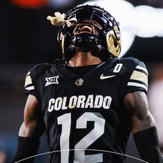 a football player wearing a black and gold uniform