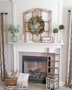 a living room filled with furniture and a fire place in front of a white fireplace