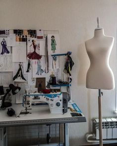 a sewing machine sitting on top of a table next to a white mannequin