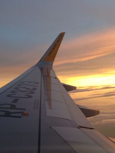 the wing of an airplane as the sun sets