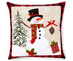 a snowman pillow with christmas decorations on it