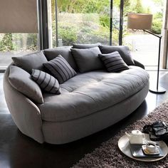 a living room filled with furniture and a large window