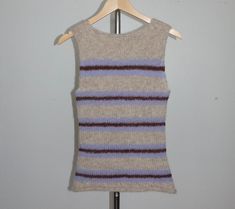 a sweater vest hanging on a clothes rack