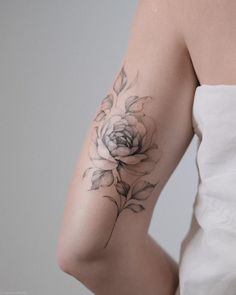 a woman with a flower tattoo on her arm