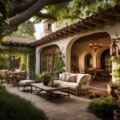 an outdoor living area with patio furniture and potted plants