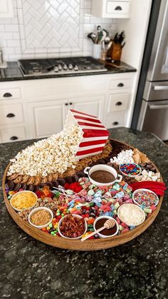 a platter filled with popcorn, candy and an american flag is on the kitchen counter