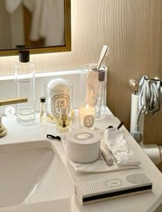 a bathroom sink with personal care items on it