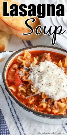 a bowl of lasagna soup with bread on the side