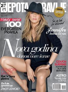 a woman sitting on top of a stool in front of a magazine cover with her legs crossed