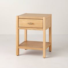 a small wooden table with one drawer on the bottom and two drawers on the top