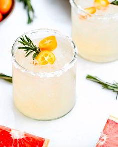 grapefruit cocktail with rosemary garnish and blood oranges on the side