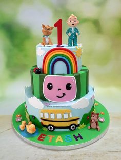 a birthday cake with an image of a school bus and two children's characters on top