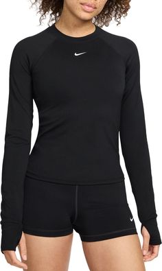 Ready to turn up the heat on your workout? Reach for this fitted long-sleeve top. Thumbholes help keep the sleeves in place through your entire routine. Lightweight and stretchy, the smooth fabric dries quickly and works with you through every move. Mesh panels under the arms let moisture escape so that finishing strong is no sweat. Fit & Design: Fitted Lightweight and stretchy fabric Mesh panels under the arms help increase airflow Thumbholes help keep sleeves in place Nike Dri-FIT technology moves sweat away from your skin for quicker evaporation, helping you stay dry and comfortable Long Sleeve Athletic Shirt, Long Sleeve Workout Shirt, Womens Athletic Outfits, Gym Clothes Women, Workout Fits, Fitness Clothing, Workout Outfit, Running Tops, Athletic Apparel