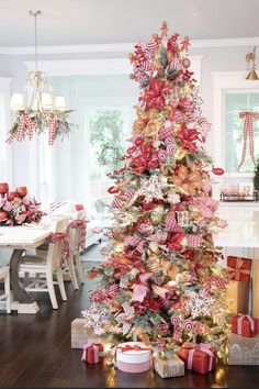 a christmas tree decorated with candy canes and bows