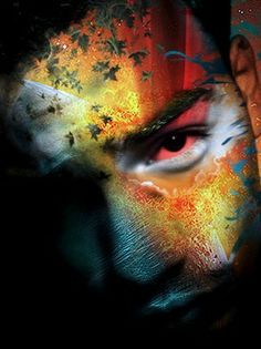 a man's face painted with multicolored paint and an artistic expression on his face