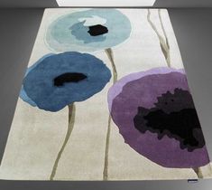 an area rug with blue and purple flowers on it