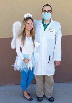 a man and woman in white lab coats standing next to each other with masks on