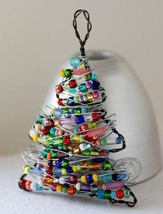 a glass christmas tree ornament with colorful beads