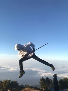 a person jumping in the air with ski poles