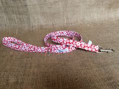 a red and white dog leash on a brown background