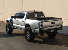 a silver truck parked in front of a building