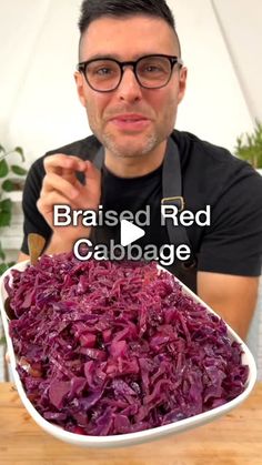 a man holding a large bowl filled with red cabbage