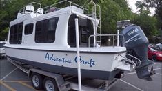 a white and blue boat parked in a parking lot