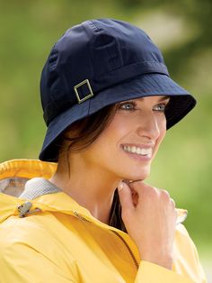 Even when gray skies refuse to clear up, you'll put on a happy face when wearing this stylish cloche. That's because it's made from soft, lightweight water-resistant polyester that keeps you dry and comfy whether it's drizzling or really coming down. And when the sun finally does appear, the 21/2" wide trapunto-stitched brim offers plenty of shade and protection. Finished with a smart silvertone buckle along the crown and the hat easily folds up to keep in your purse or coat pocket. One size fits most. Water resistant Soft and lightweight 2-1/2 trapunto-stitched brim 100% polyester Spot clean Imported | Women's Cloche Rain Hat - Navy - The Vermont Country Store Put On A Happy Face, Vermont Country Store, Rain Hat, Coat Pocket, Grey Skies, Cloche Hat, Country Store, Direct Marketing, Wide Brimmed Hats