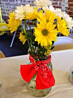 a vase filled with yellow flowers sitting on top of a table