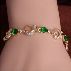 Gold Plated Green Cubic Zirconia & Hearts Bracelet. Measures 8” Inches. Color In Person Looks Most Like First Picture. New Condition And Comes In A Gift Box. Bundle & Save: Bundle 2 Or More Items For A Private Discount Next Day Shipping On All Orders 5 Star Rated Poshmark Ambassador Elegant Green Heart-shaped Bracelet, Wave Bracelet, Crystal Fashion, Heart Chain, Green Crystal, Bangles Jewelry, Colorful Bracelets, Austrian Crystal, Crystal Heart