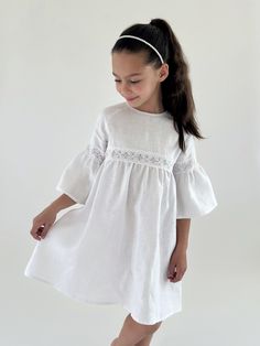 This girl white linen dress with lace will give your girl that cute baby doll look. Beautiful linen fabric with cotton lace inserts, flattering sleeves, and a zipper on the back make this white linen sundress a great go to for any event.  This free fitting white boho dress is an ideal special occasion outfit for your little one - a perfect choice for a christening gown or a flower girl dress.  Also available in beige (warm vanilla) color. Care instructions for linen clothing: - machine wash cold on gentle cycle with alike colors;  - hang or lay flat to dry;  - iron after washing or shipping. Color might vary due to differences in viewing devices. Vanilla Color, White Babydoll Dress, White Linen Dress, Linen Sundress, Occasion Outfit, Dress With Bell Sleeves, Girls White Dress, White Boho Dress, Christening Gown