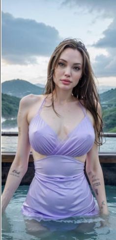 a woman in a purple bathing suit standing in the water