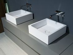 two white sinks sitting next to each other in a bathroom