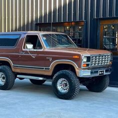 a brown truck parked in front of a building