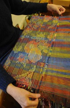 a woman working on an art project with yarn