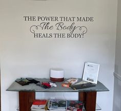 there is a table with magazines on it and a sign that says, the power that made the body heals the body?