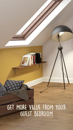 a bed sitting under a window next to a lamp on top of a wooden floor