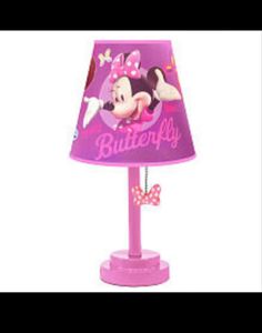 a pink lamp with minnie mouse on it and a butterfly hanging from the side of the lamp