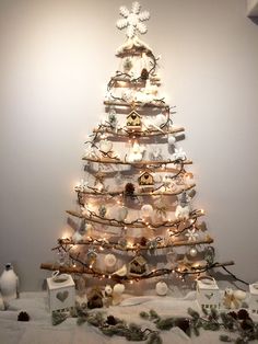 a white christmas tree with lights and ornaments