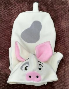 a white cow with pink ears on it's head