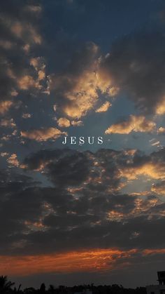 the word jesus written in white letters on a cloudy sky