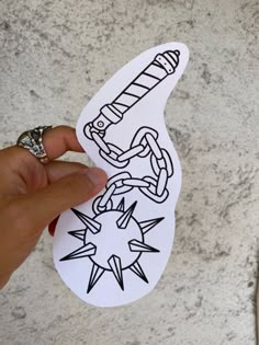 someone is holding up a sticker with an arrow and chain on it